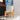 White Dispenser alongside four blue water bottles with labels.